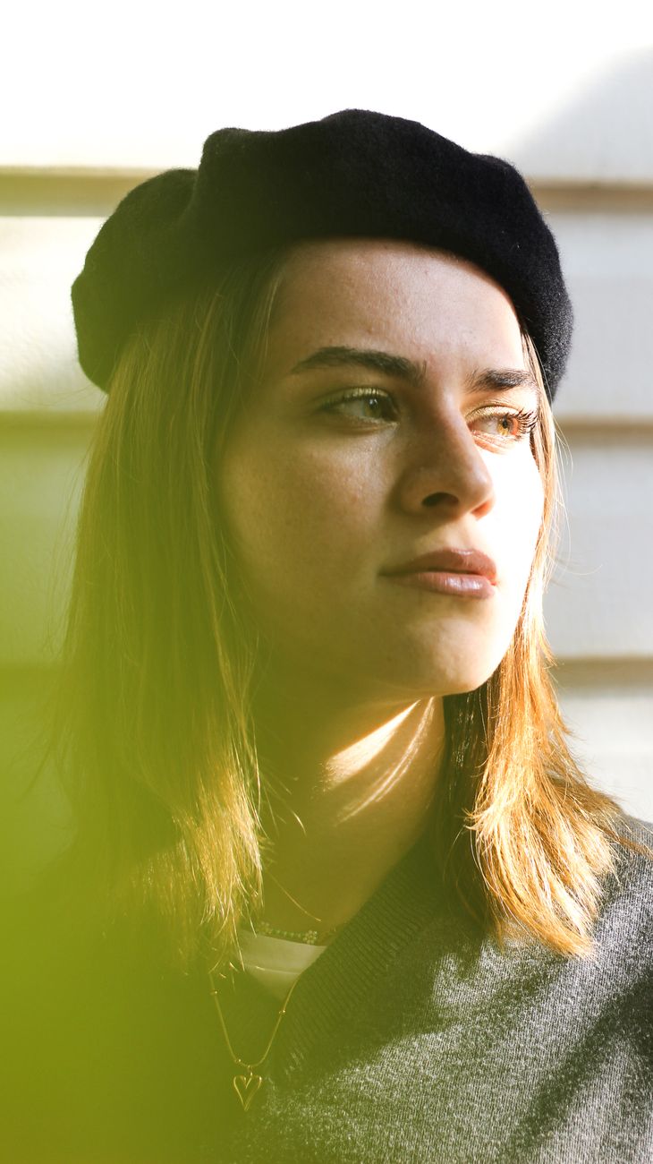 Inspirational woman in beret thinking as premium digital culture concept